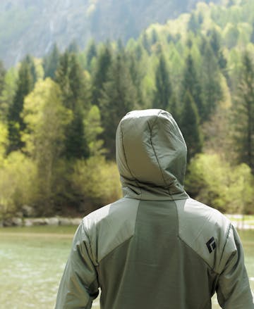 A hiker wearing the First light Hybrid hoody for a fall hike in the mountains. 