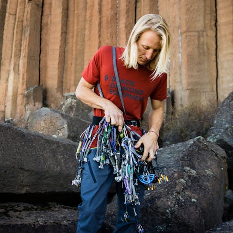 A climber with a large rack of cams.