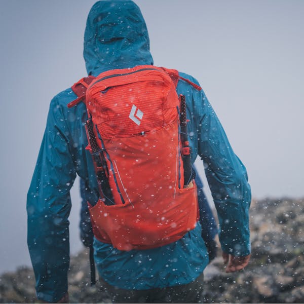 A hiker wearing the Black Diamond Stormline Stretch shell and Pursuit 30 pack.  