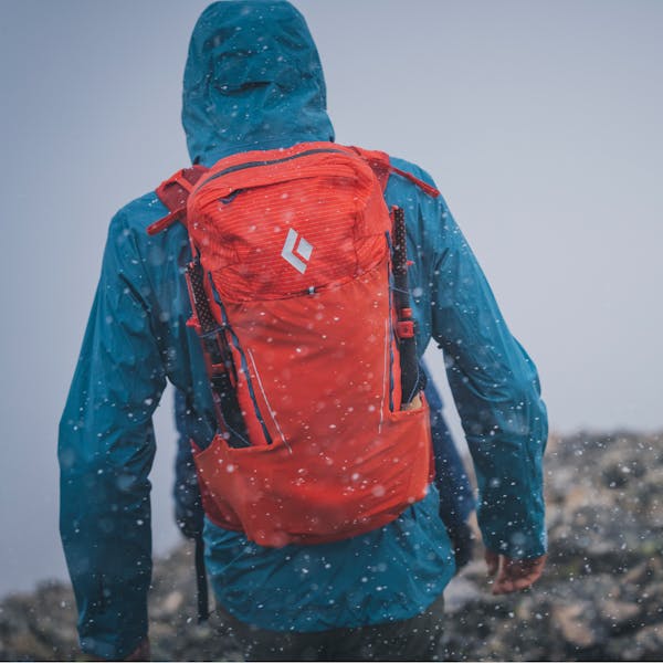 A hiker wearing the Black Diamond Stormline Stretch shell and Pursuit 30 pack.