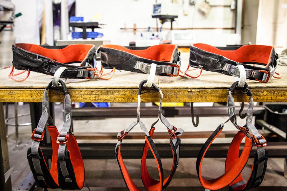 multiple harnesses hanging off a work bench