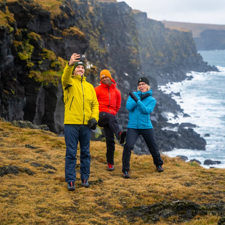 Three Hikers posing for a photo wearing Black Diamond Fall Hiking apparel on a cold drizzly day. 
