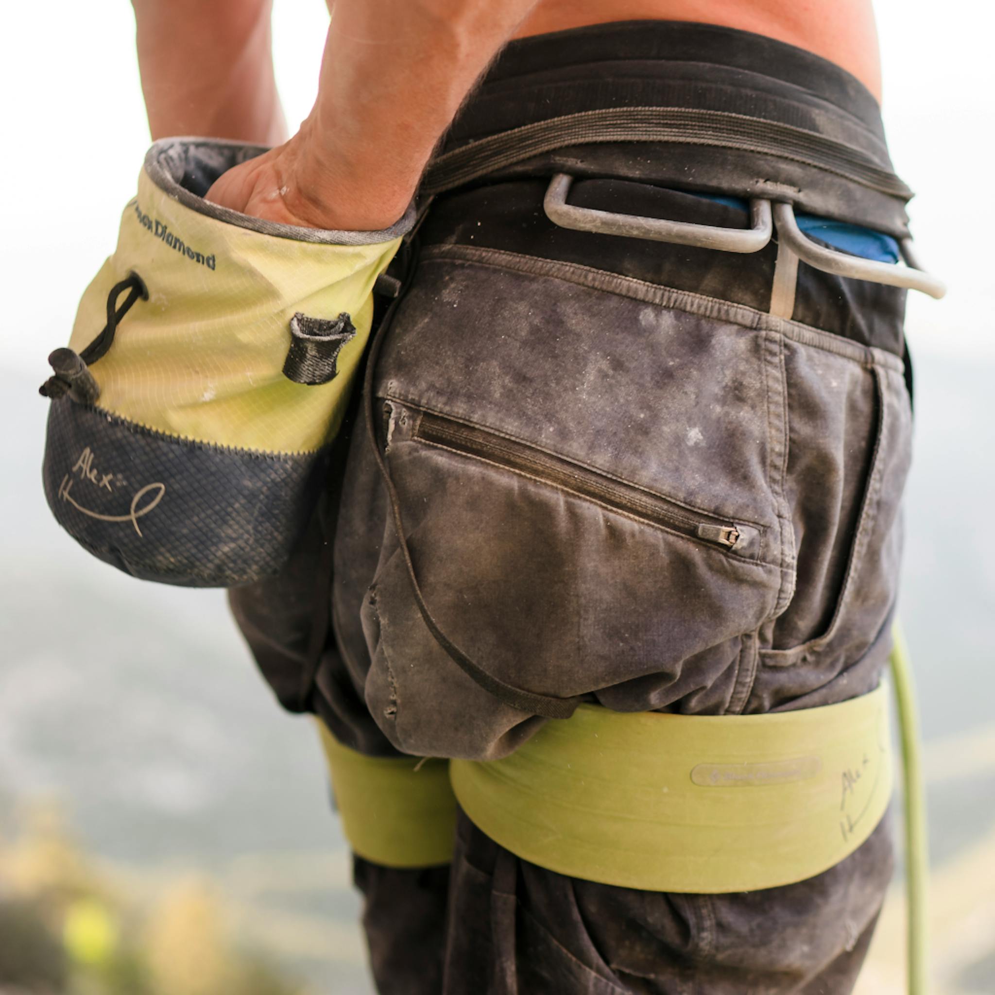 BD Athlete Alex Honnold reaches into his chalk bag wearing a Solution Harness- Alex Honnold Edition.