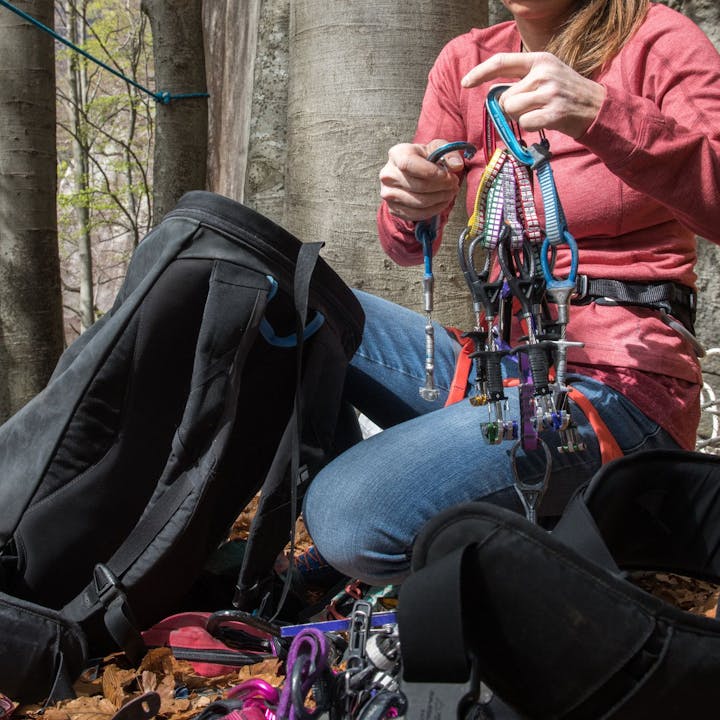 Photograph by Andy Earl of BD Athlete Babsi Zangerl organizing climbing gear outside