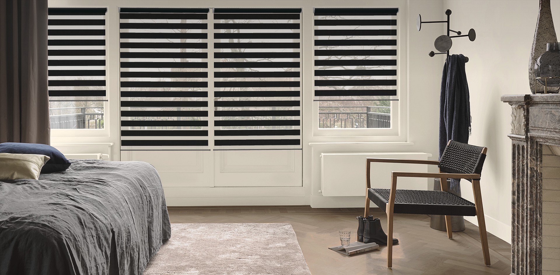 Double roller blinds filtering daylight across windows in a bedroom
