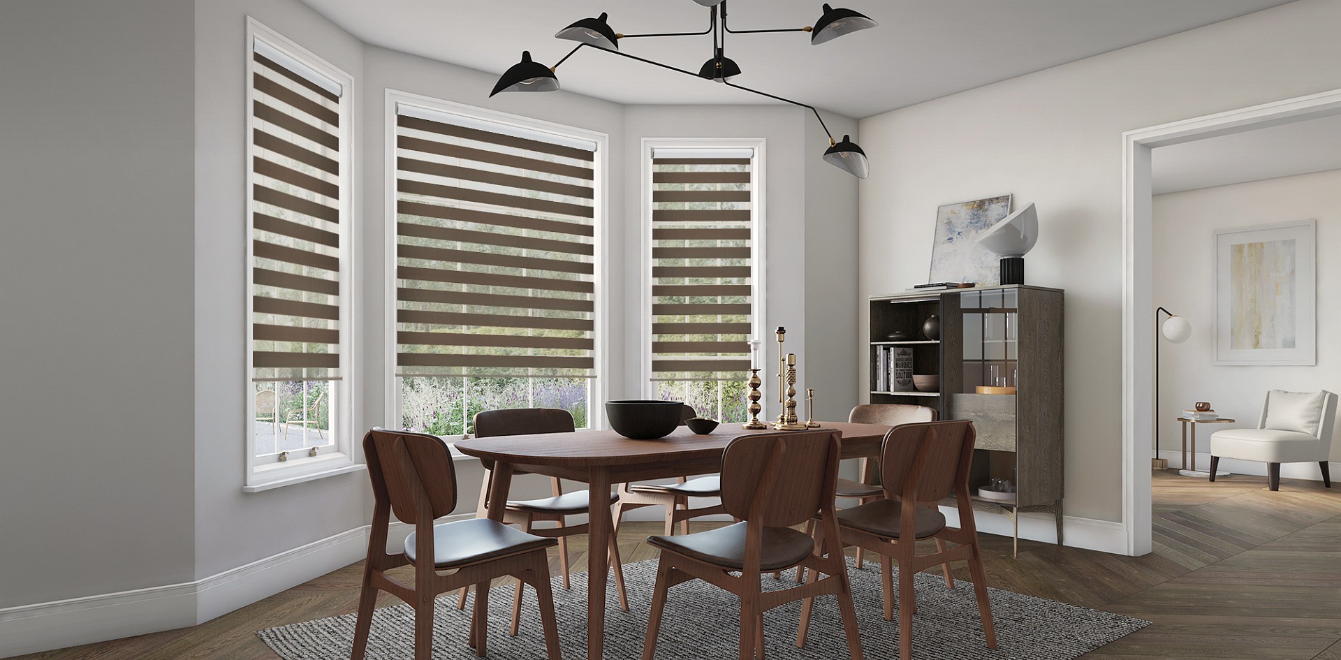 Double roller blinds filtering daylight across three windows in a dining room
