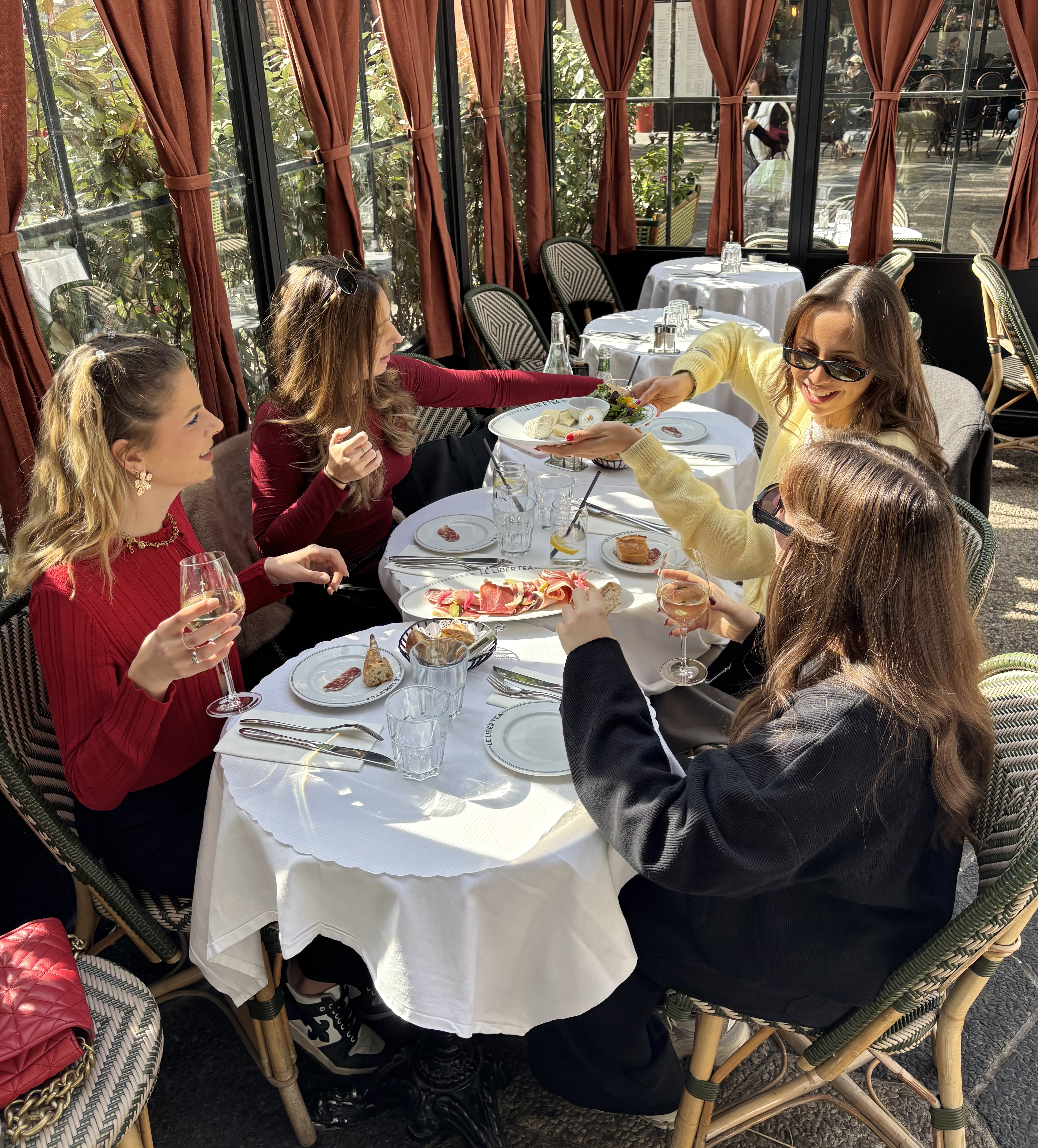 Quatres femmes autour d'une table buvant un verre