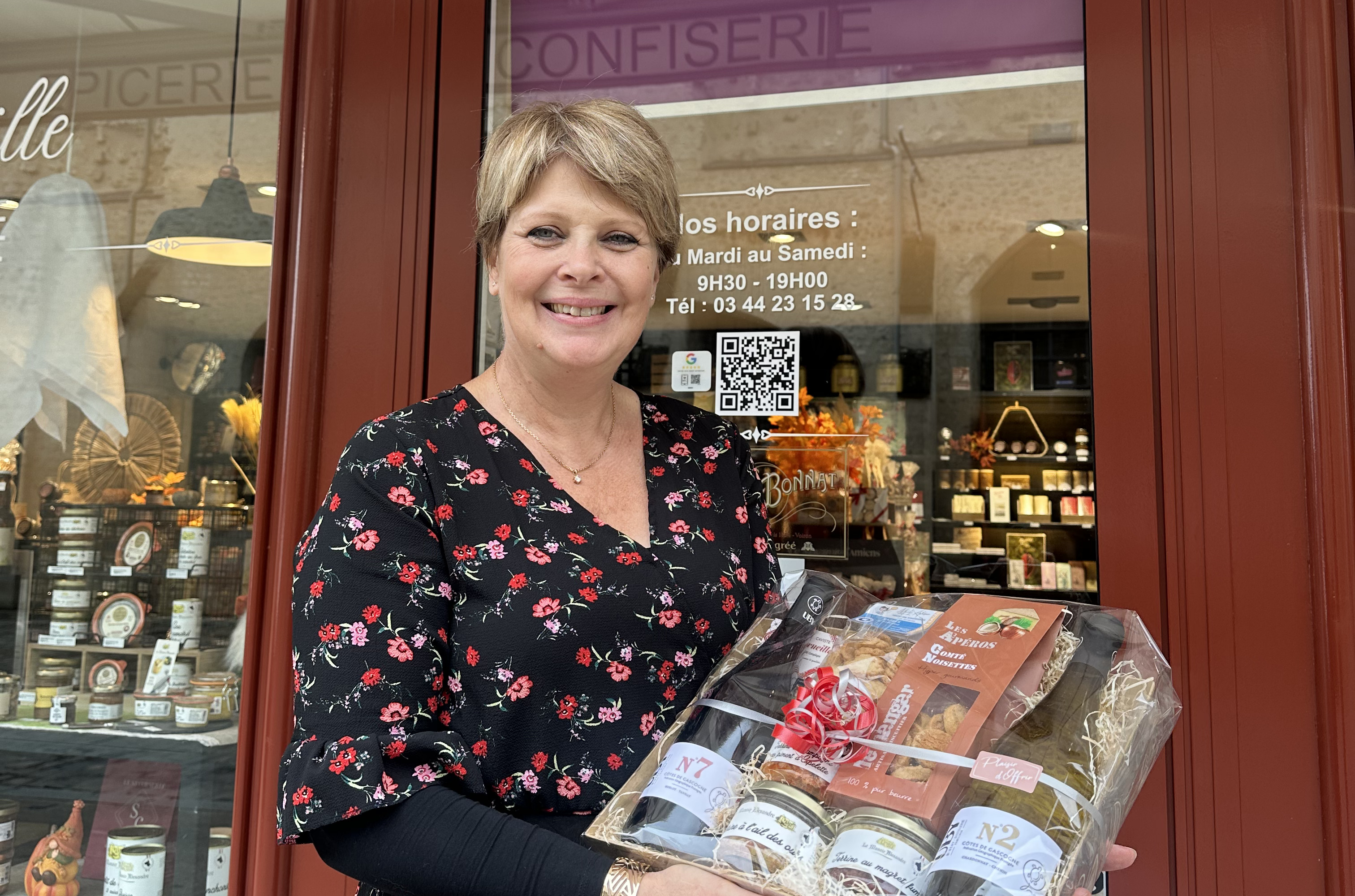Dame devant une boutique avec panier garni