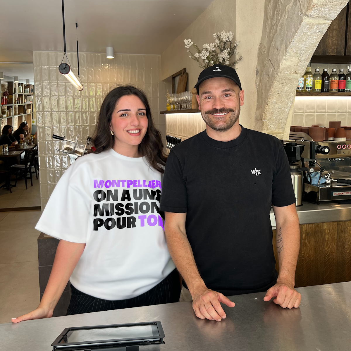 Un homme et une femme derrière un bar