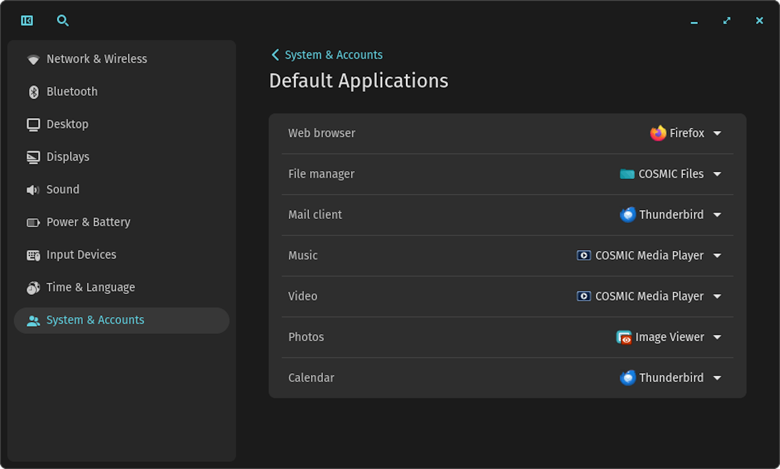 The Default Applications settings page in COSMIC Settings shows dropdown menus for selecting your default apps. This example includes the following: Firefox web browser, COSMIC Files file manager, COSMIC Media Player for both music and video, Image Viewer for photos, and Thunderbird for both mail client and calendar.