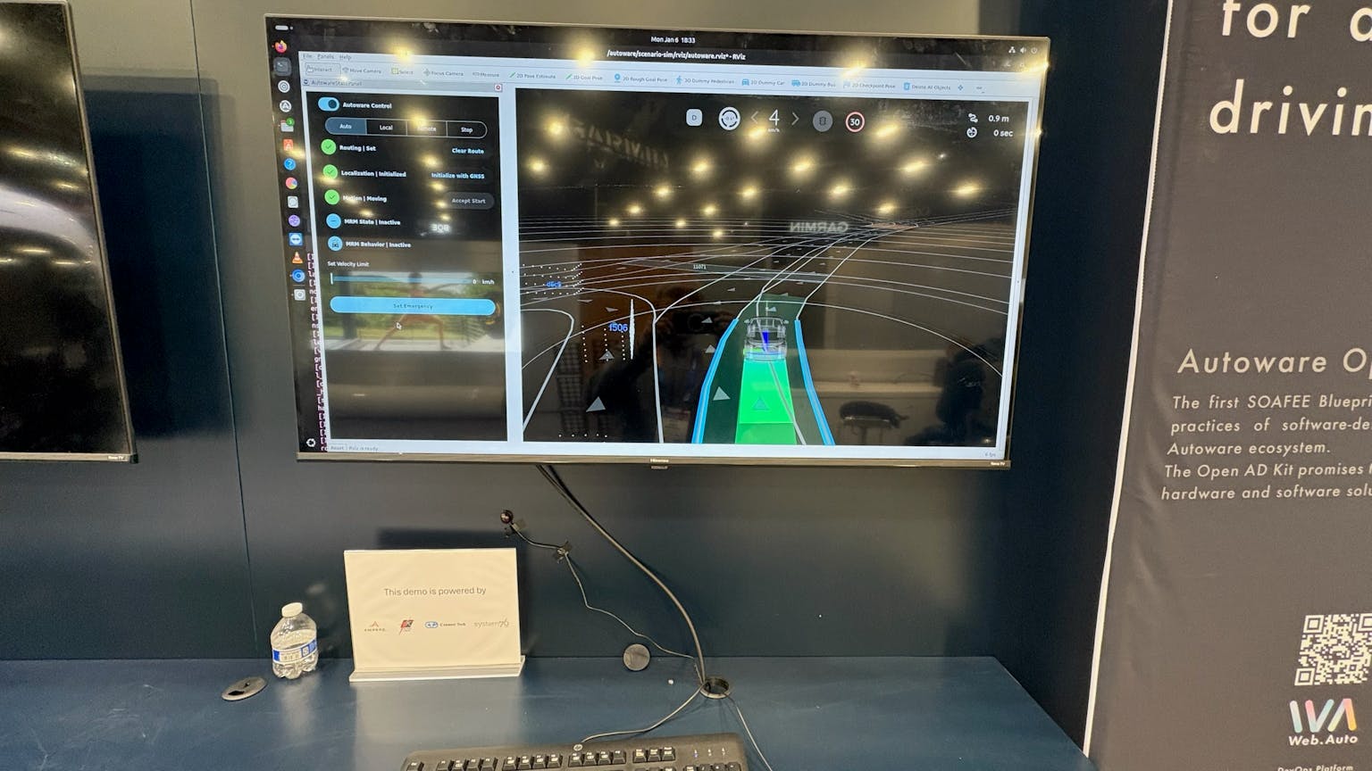 At Tier IV’s booth, a monitor shows off a driving simulator running on the Thelio Astra.