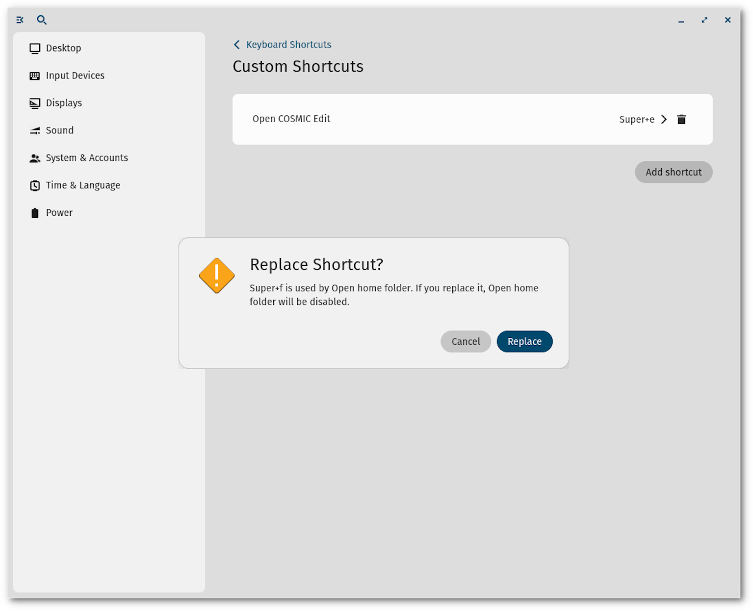 A user is attempting to change the COSMIC Edit shortcut in Keyboard Shortcuts settings to Super+f from Super+e. An error message has popped up informing this user that a Super+f shortcut is already in use for opening the home folder.