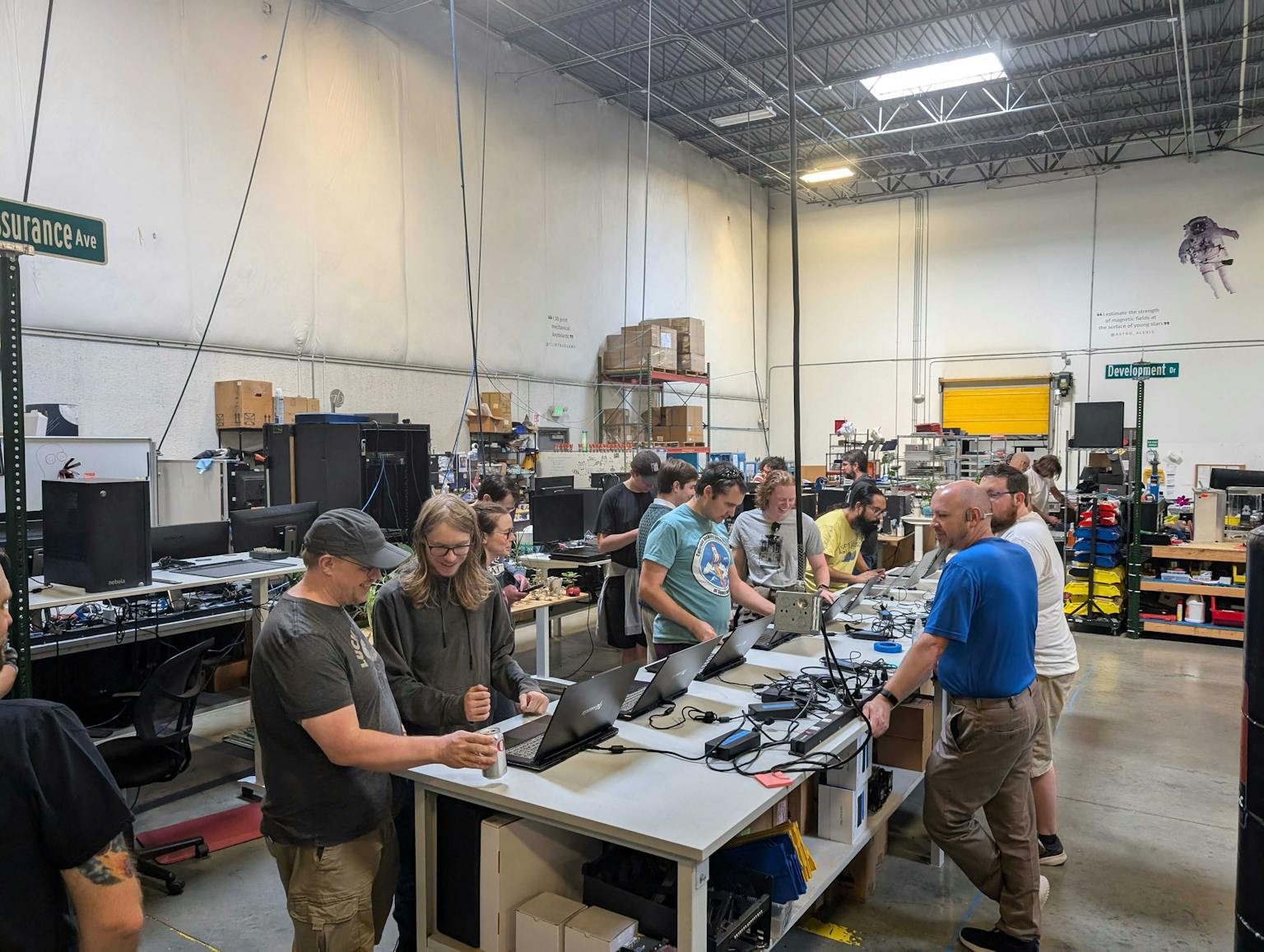 people looking at laptops in the qa area