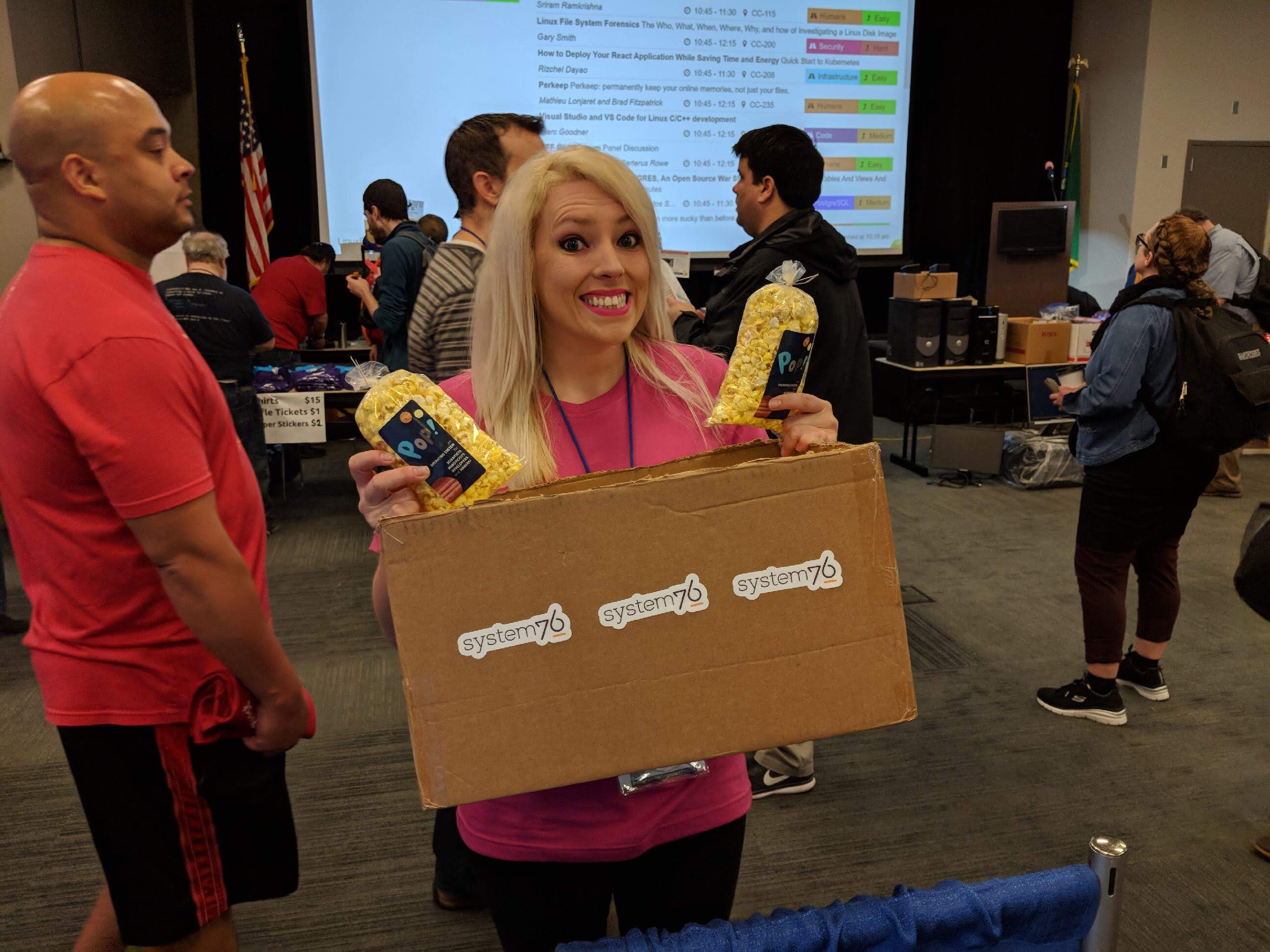 Emma with box of Popcorn at Linux Fest Northwest 2018.