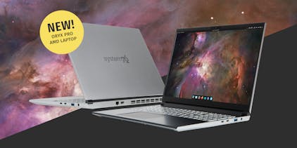 Front and back photos of the new Oryx Pro, lid open, featuring a silver aluminum exterior and Pop!_OS 24.04 LTS beta with the COSMIC desktop.