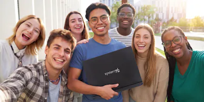 college students smiling and holding up an Adder Pro laptop