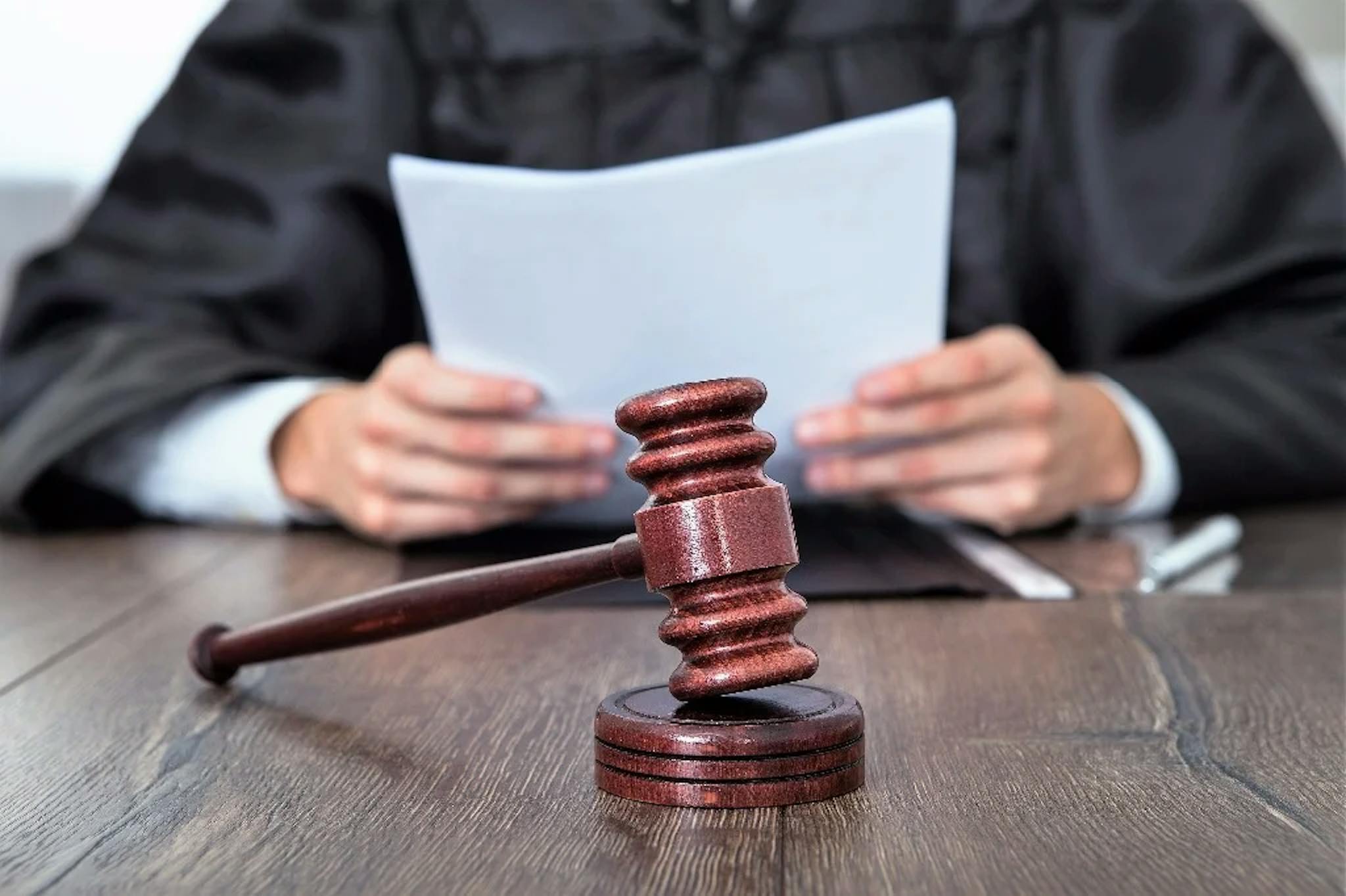 Man holding paper and gavel