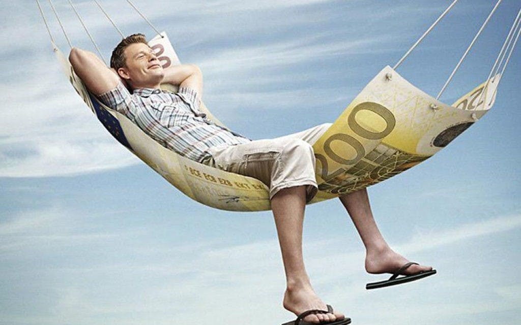 Man lying in a hammock of money