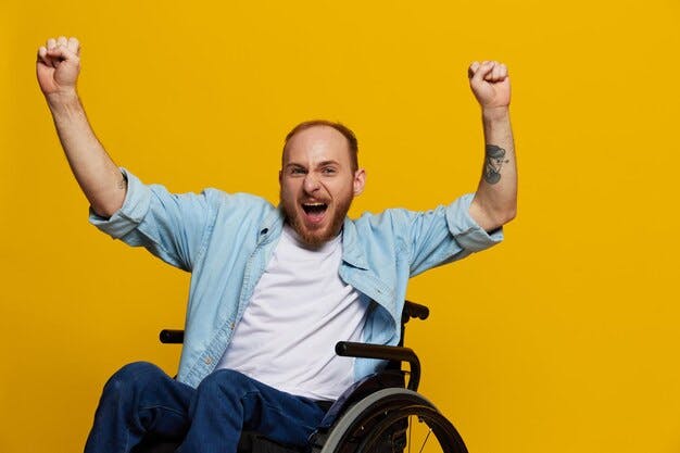 Man in a wheelchair celebrating