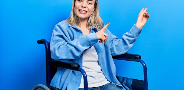 Woman in a wheelchair pointing upward