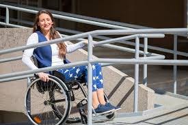 Woman in a wheelchair going up a ramp