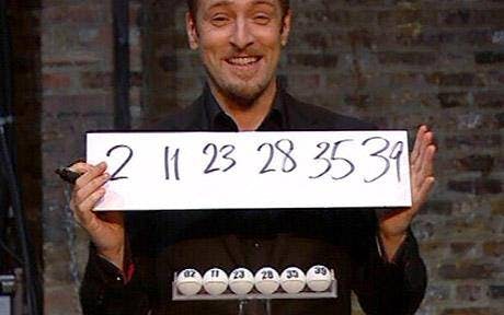 Man holding sign with numbers