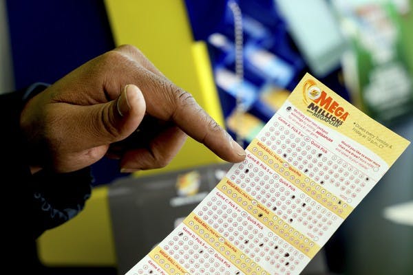 Finger pointing at lottery ticket
