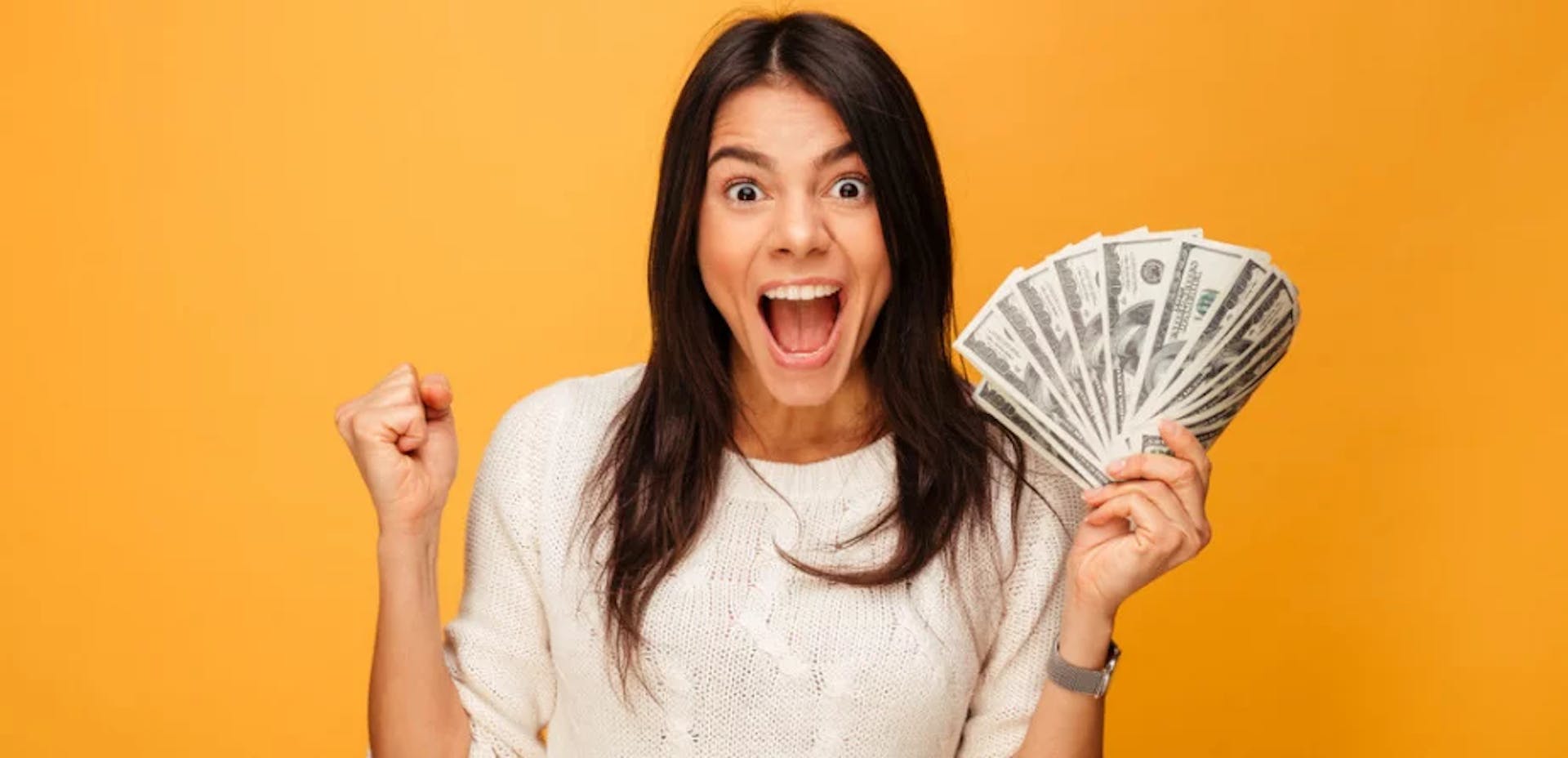 Happy woman holding money