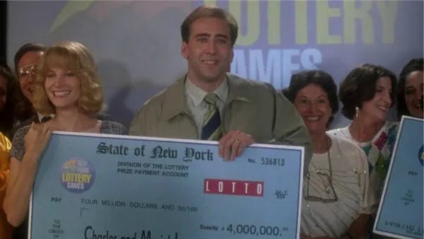Couple holding lottery prize