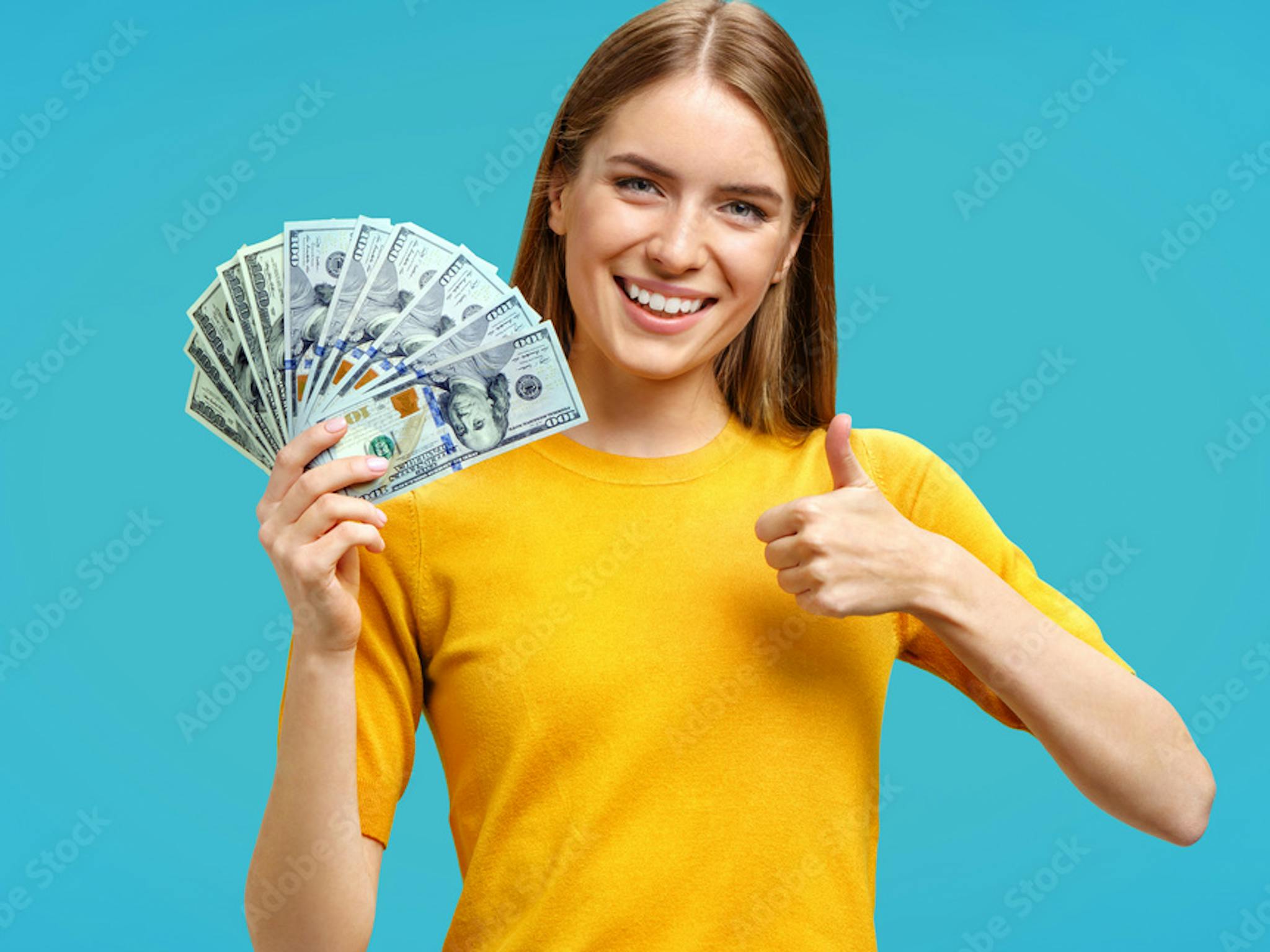 Young woman holding money with a thumbs-up sign