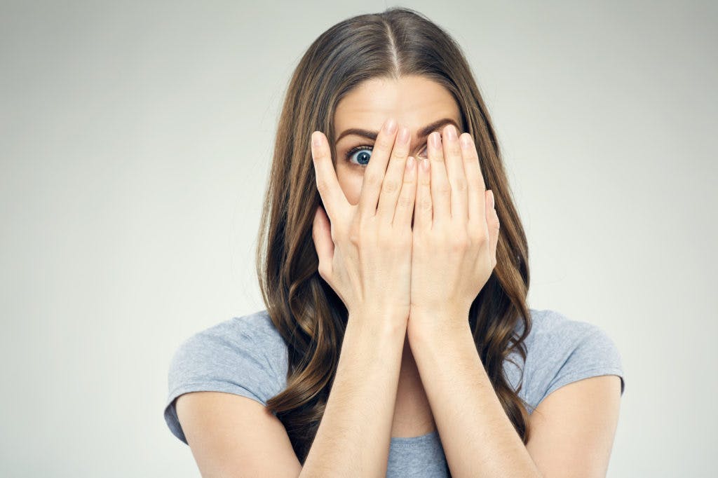 Woman with hands over face