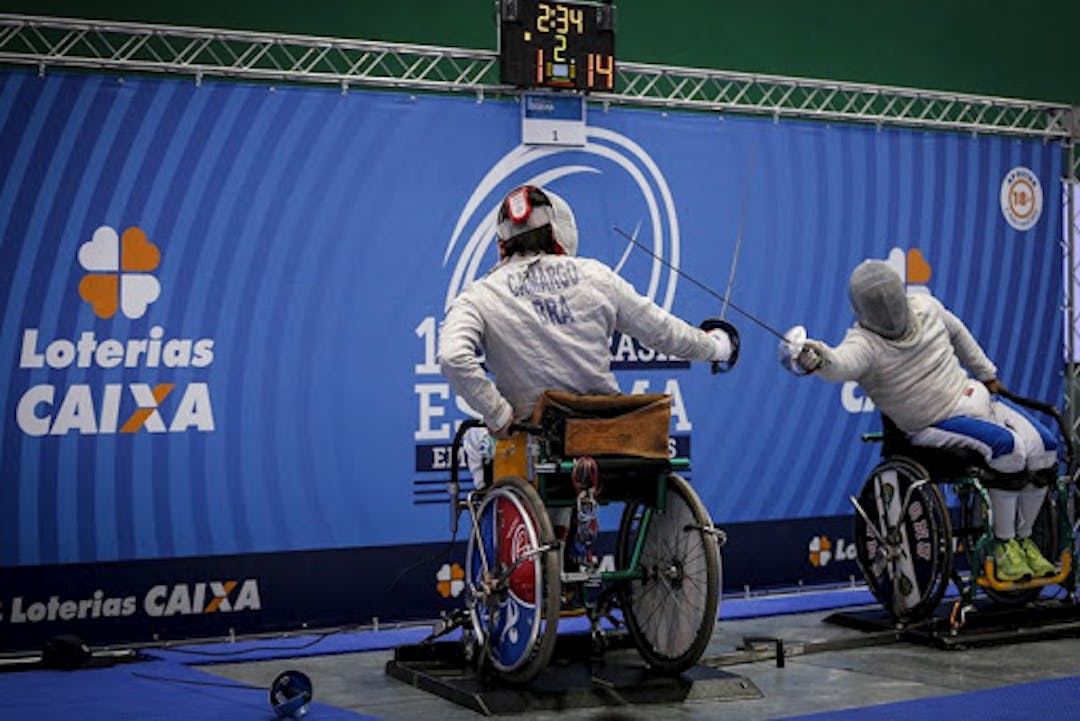 People in wheelchairs fencing