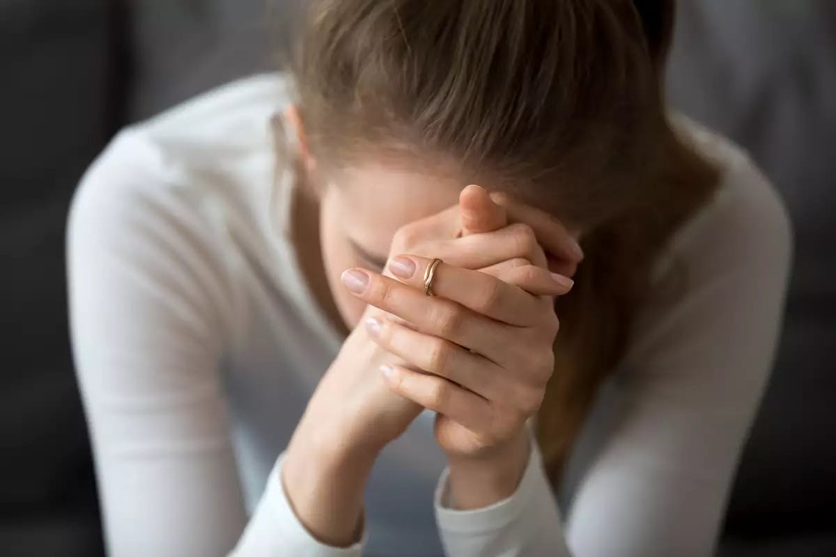 Woman with hands on her face
