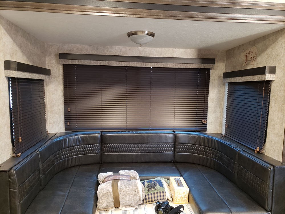 rv built in couch with mini blinds on window