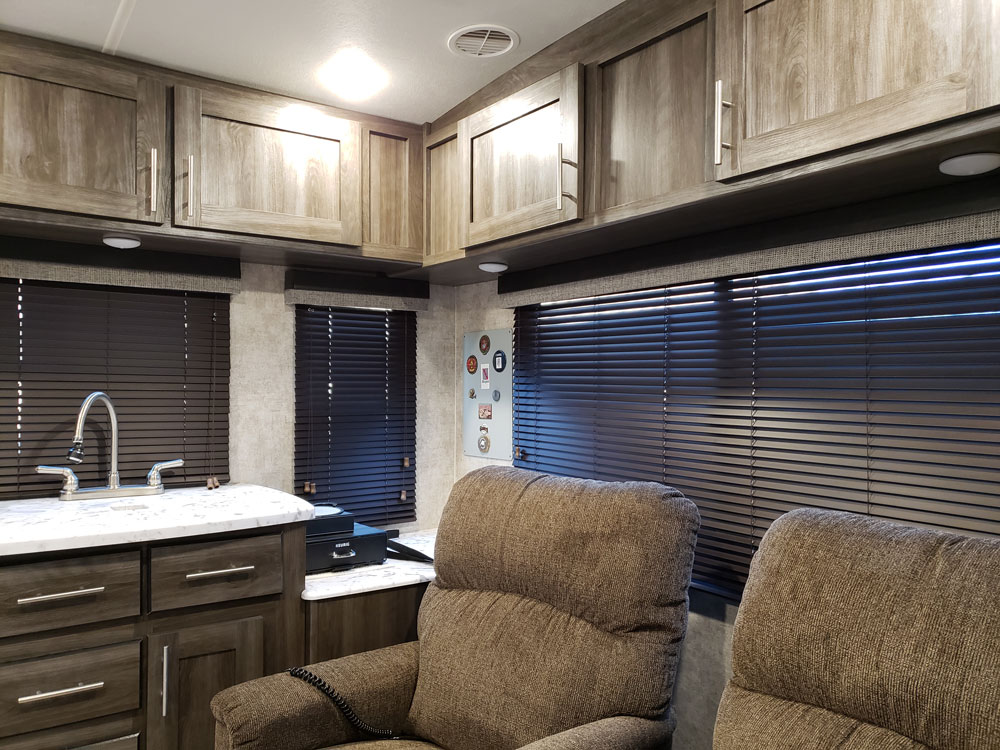 camper interior with brown mini blinds on windows