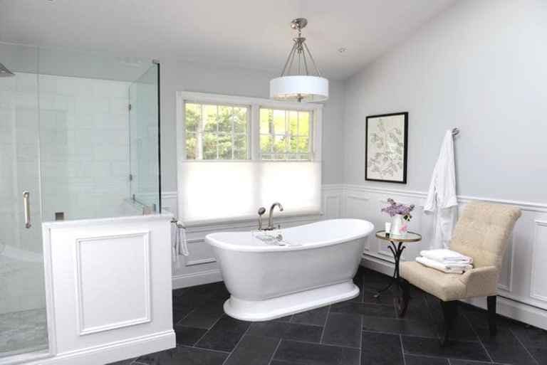 traditional bathroom with freestanding tub and white cellular shades on window with top down option