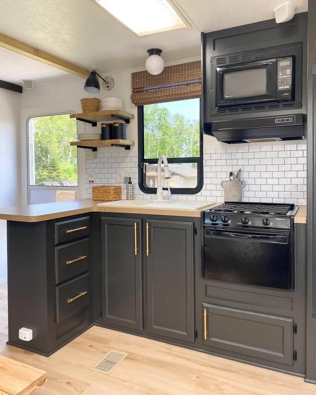 Kitchen with woven wood shades inside of an RV