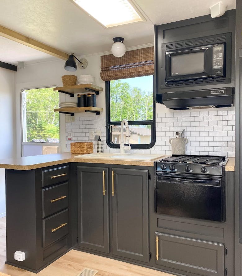 Kitchen with woven wood shades inside of an RV