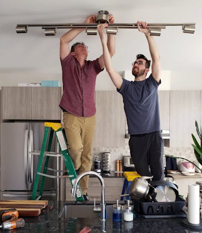 father and son working on a Father's Day home improvement project in a kitchen