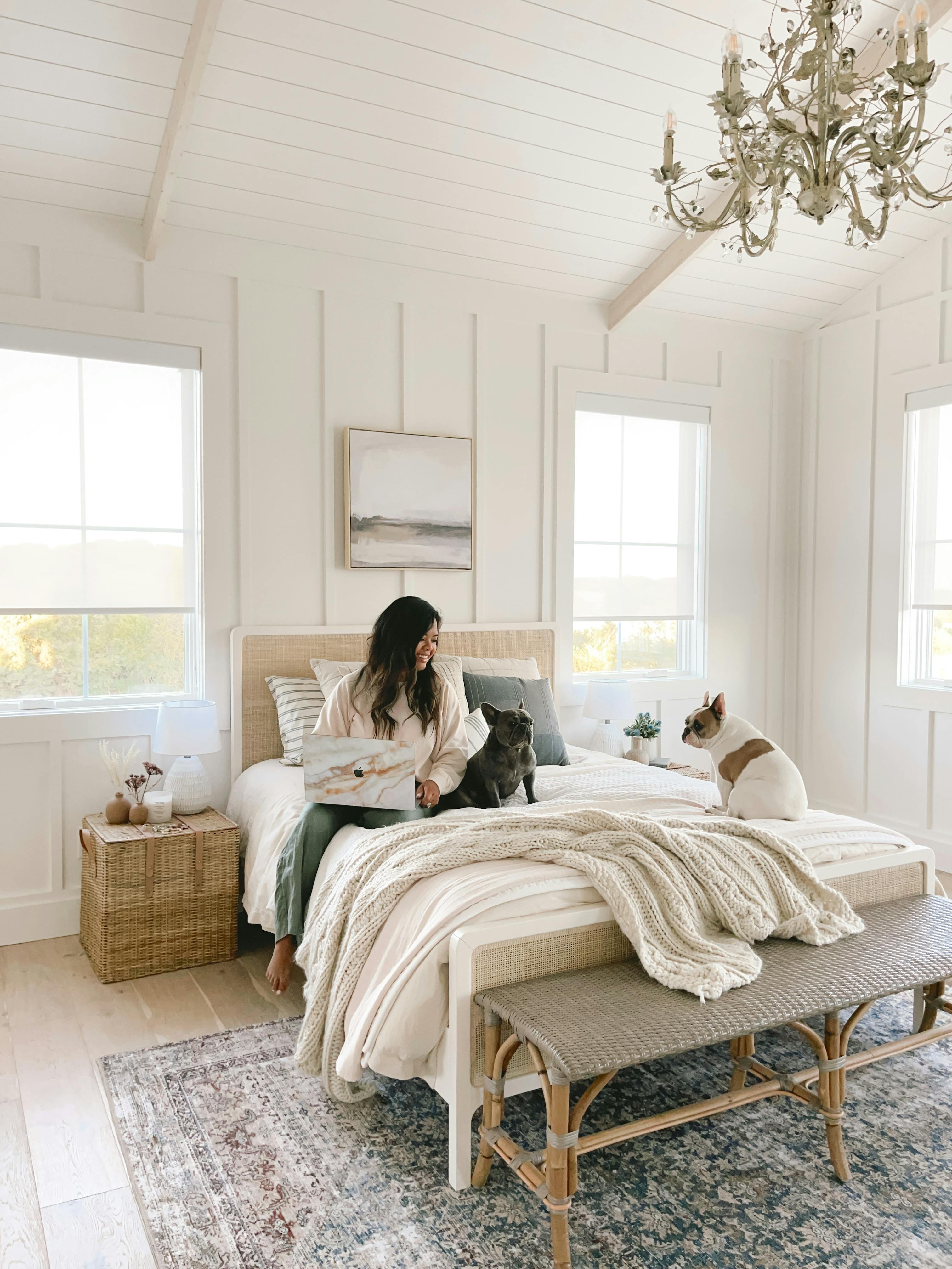 Nina is sitting on her bed with her two dogs.