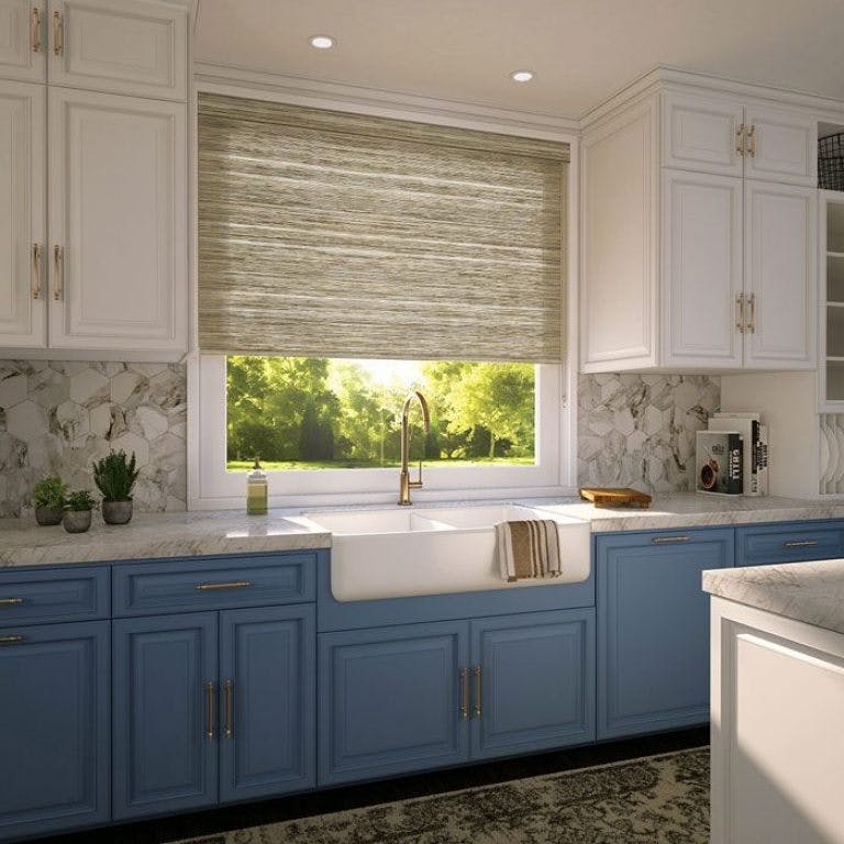 beautiful kitchen with white upper cabinets and lower cabinets and woven grass window shade over the kitchen sink