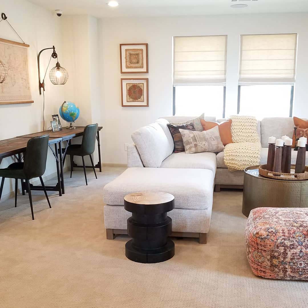 Neutral toned, open concept living room and workspace.
