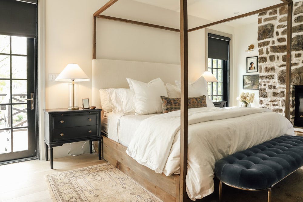 modern traditional bedroom with black roller shades on patio doors