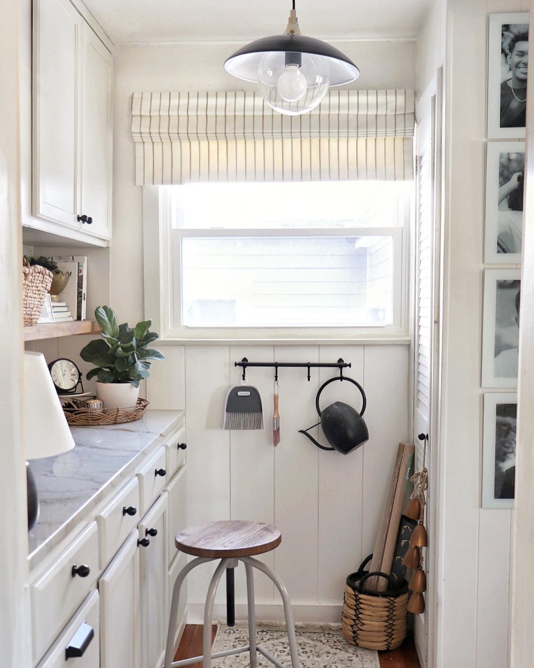 All white workshop area with Premium Roman Shades on the window. 