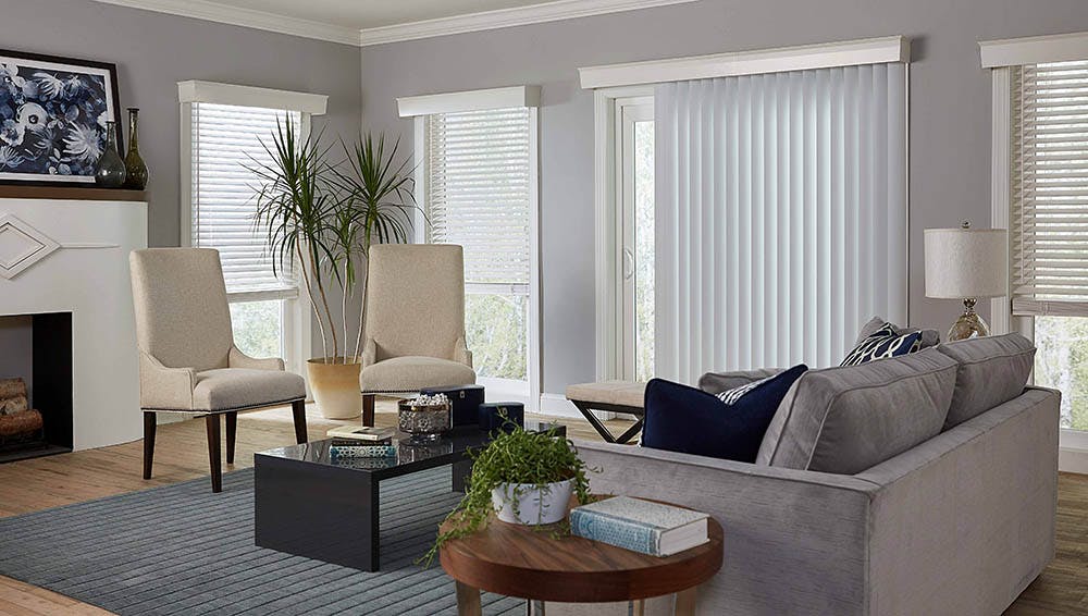 contemporary living room with sliding glass door covered with vertical blinds.