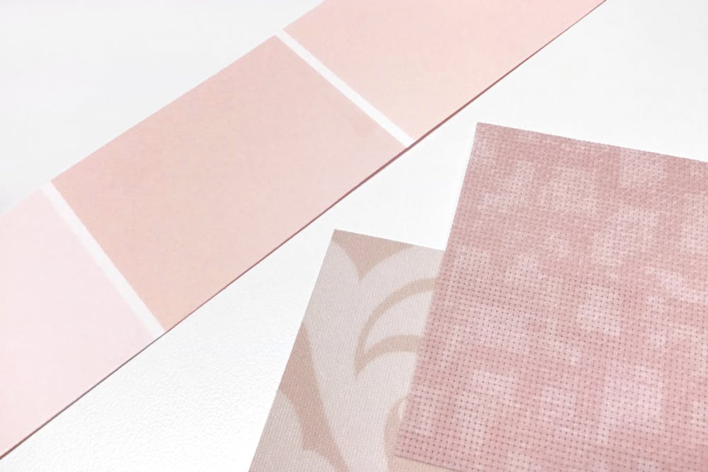 Pink paint swatches ext to pastel pink solar shade fabric samples