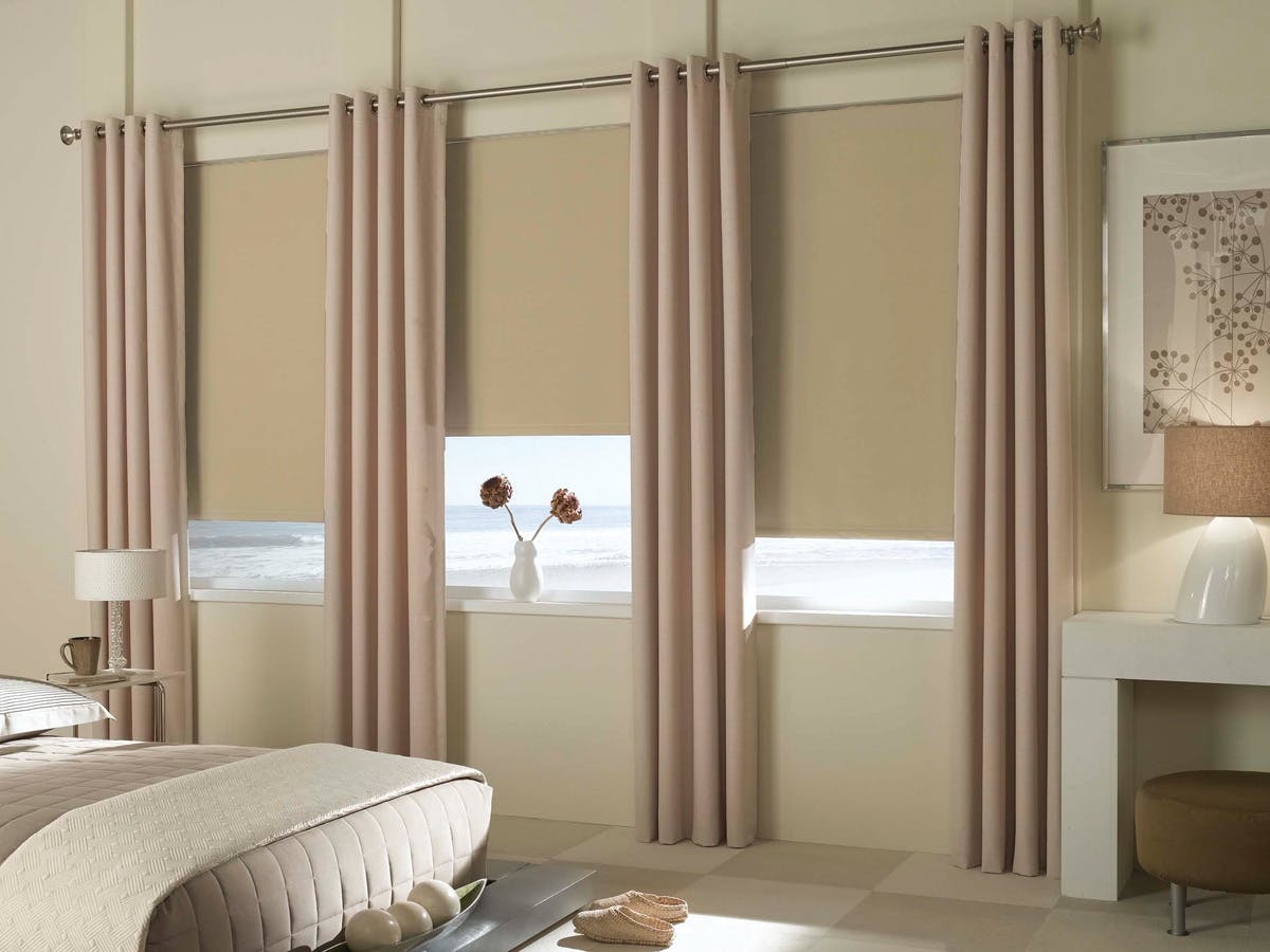 A modern bedroom with EZ-A Motorized Blackout Roller Shades