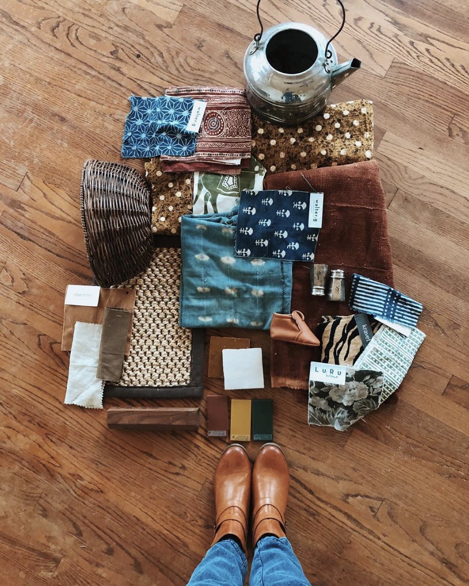 woman taking photo of home decor mood board from above