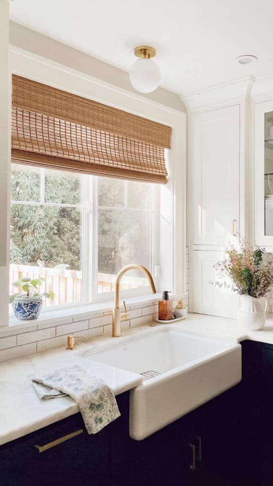 farmhouse kitchen with blinds.com woven wood shades over the farmhouse sink
