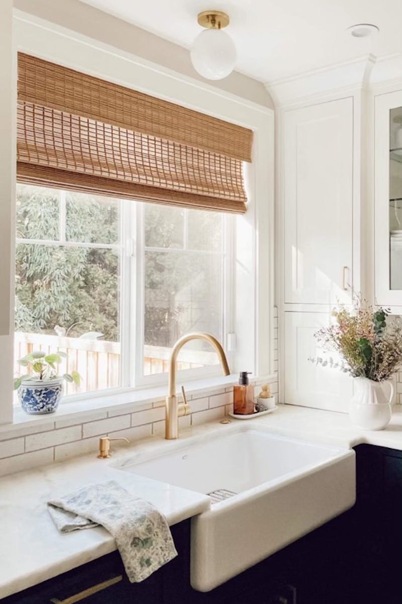 farmhouse kitchen with blinds.com woven wood shades over the farmhouse sink